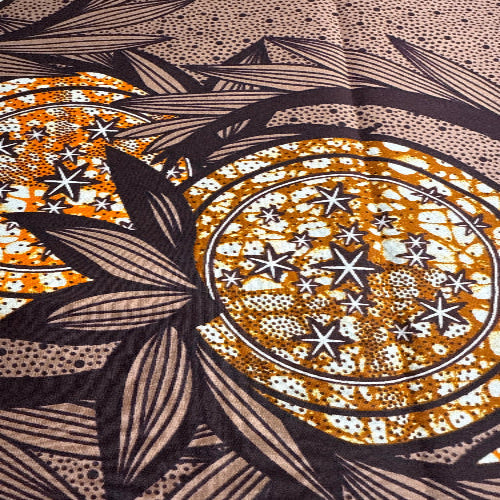 Decorative pattern with circular design, stars, and leaves on a textured background