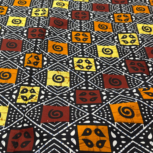 Patterned fabric with geometric shapes in black, yellow, and brown on a black background