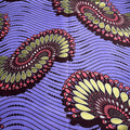Decorative fabric with circular patterns on a purple background