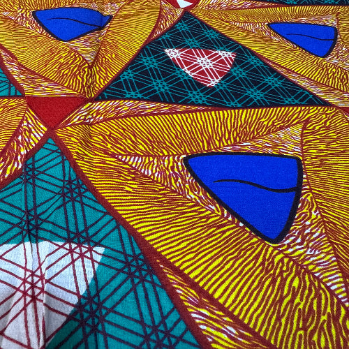 Close-up of a colorful geometric pattern with blue, yellow, and red shapes.