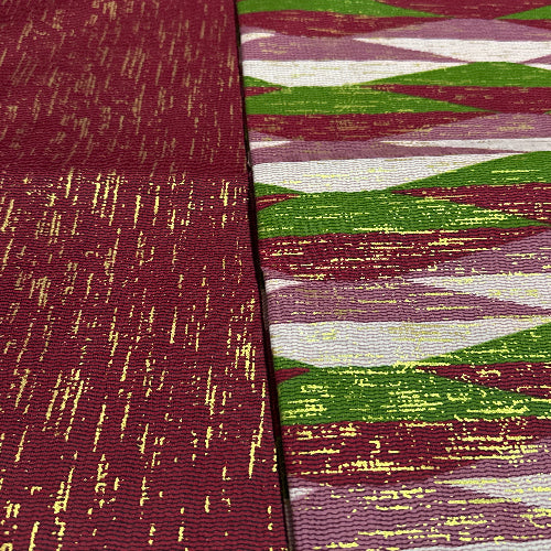 Close-up of a fabric with a patterned texture in red, green, and white.