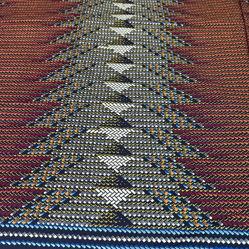 Close-up of a woven fabric with a pattern of interlocking shapes in various colors.
