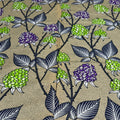 Floral pattern with green, purple, and black flowers on a beige background
