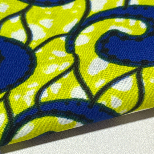 Close-up of a fabric with blue and black abstract patterns on a yellow background