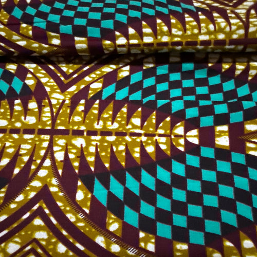 Close-up of colorful geometric patterned fabric with a focus on texture and color.