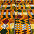 Close-up of a vibrant African fabric with geometric patterns in orange, black, and yellow.