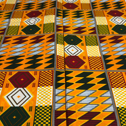 Close-up of a vibrant African fabric with geometric patterns in orange, black, and yellow.
