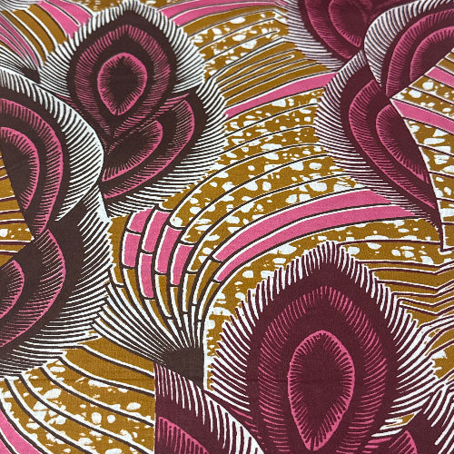 Close-up of a patterned fabric with pink, gold, and white colors.