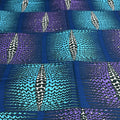 Patterned fabric with blue, purple, and black wavy lines and zigzag designs.
