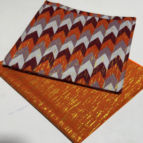 Two fabric samples with zigzag pattern and plain orange fabric on a white background