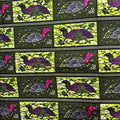 Patterned fabric with stylized birds and flowers on a black background