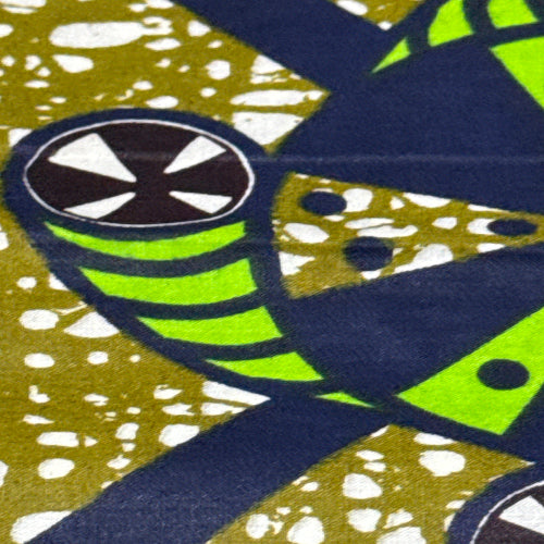 Close-up of a patterned fabric with green, blue, and gold colors.