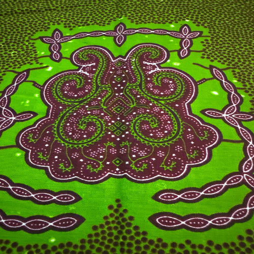 Decorative fabric with intricate paisley pattern on a green background