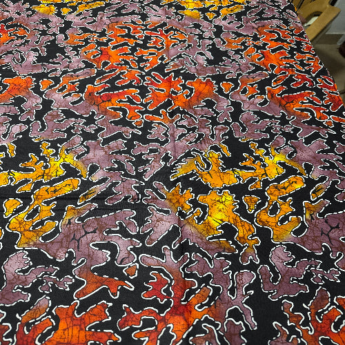 Close-up of a fabric with a multicolored abstract pattern on a black background