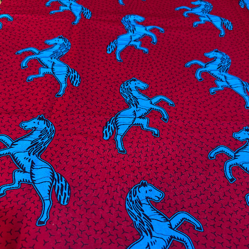 Blue animal pattern on a red fabric background