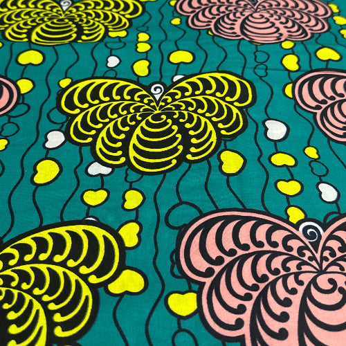 Colorful patterned fabric with abstract designs on a teal background