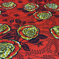 Patterned fabric with yellow roses on a red background