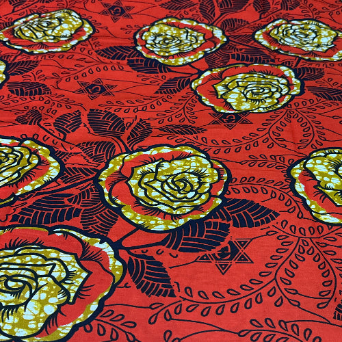 Patterned fabric with yellow roses on a red background