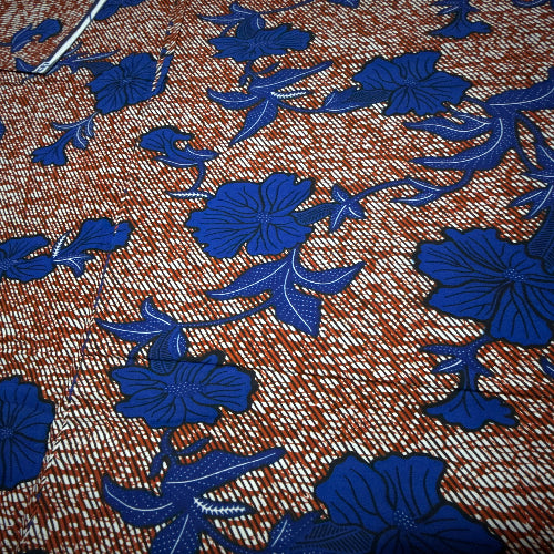 Close-up of fabric with blue floral patterns on a brown background