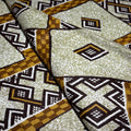 Patterned fabric with geometric design in brown, black, and beige.