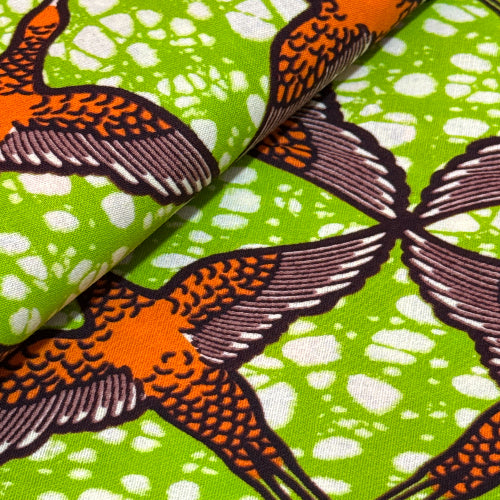 Fabric with bird pattern on a green and white background