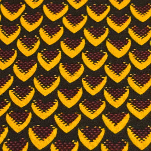 Pattern of yellow and brown shapes on a black background