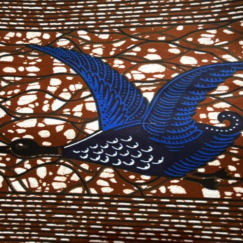 Decorative wall clock with blue peacock design on a brown and white patterned background