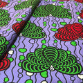 Colorful pattern with green and red shapes on a purple background