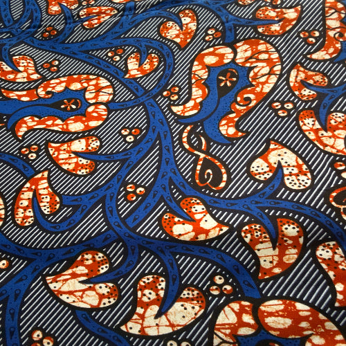 Patterned fabric with blue and orange design on a dark background