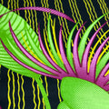 Close-up of colorful fabric with green, pink, and yellow patterns on a black background.