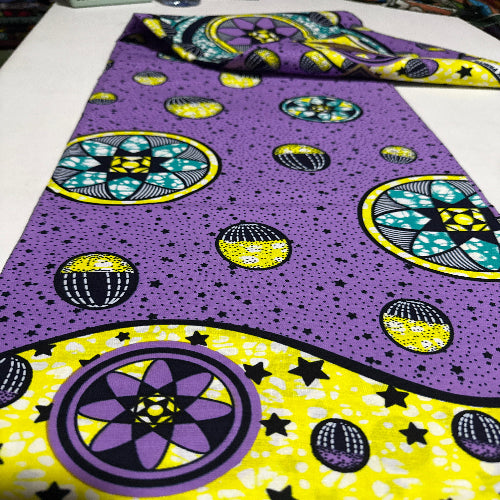 Close-up of a fabric with purple and yellow patterns