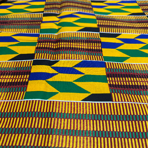 Close-up of Kente fabric with geometric patterns in yellow, green, blue, and black.