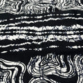 Black and white abstract pattern on a textured fabric background