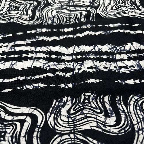 Black and white abstract pattern on a textured fabric background