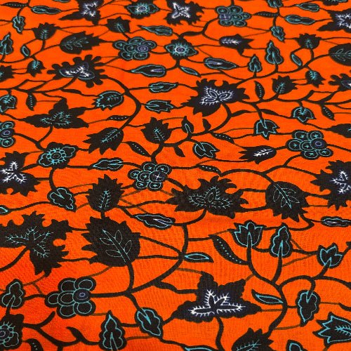 Black floral pattern on an orange background