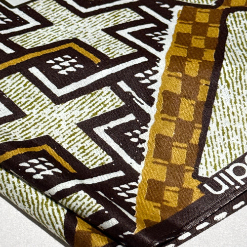 Close-up of a patterned fabric with geometric design and 'Kodak' branding.