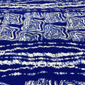 Blue and white tie-dye pattern on a fabric background