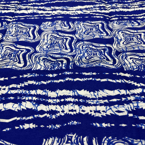 Blue and white tie-dye pattern on a fabric background