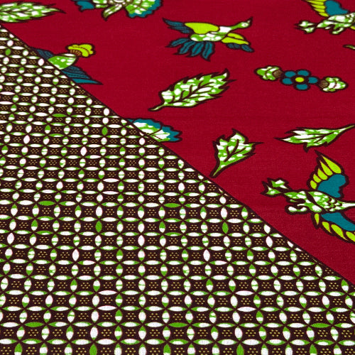 Fabric with colorful bird pattern on red background and brown geometric pattern.
