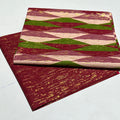 Two patterned books stacked on a white background