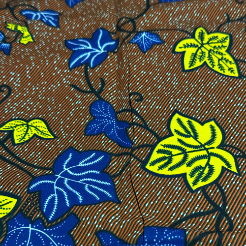 Close-up of fabric with blue and yellow leaf pattern on a brown background