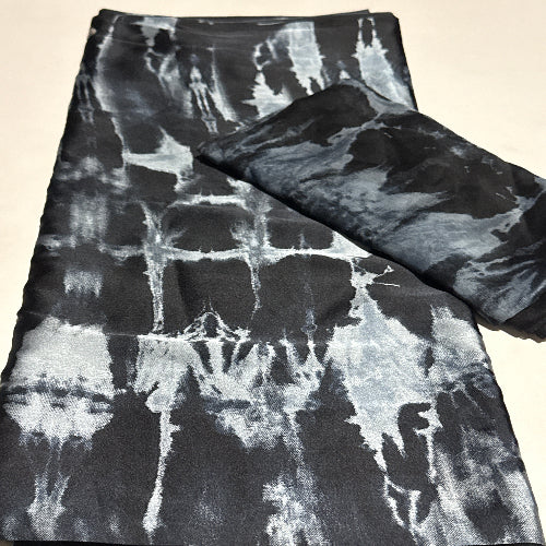 Black and white tie-dye fabric on a beige background