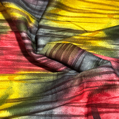 Close-up of colorful fabric with yellow, red, and gray patterns.