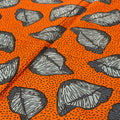 Pattern of black leaves on an orange background