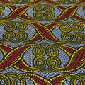 Close-up of fabric with red, yellow, and black pattern