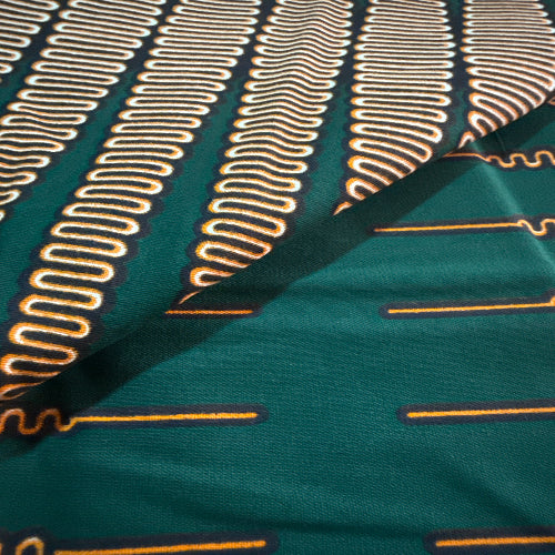 Close-up of green fabric with gold embroidery patterns