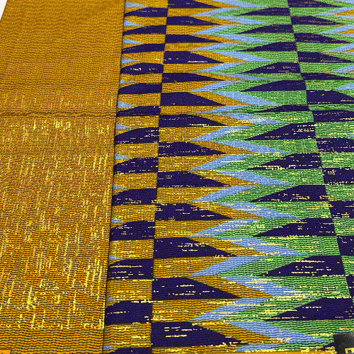Close-up of a fabric with a geometric pattern featuring green, blue, and gold colors.