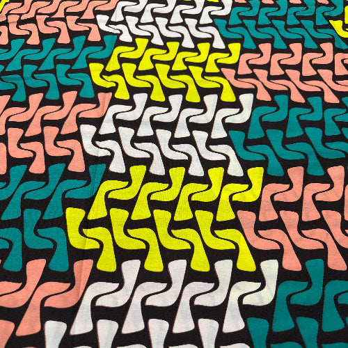 Patterned fabric with wavy lines in green, pink, white, and yellow on a black background