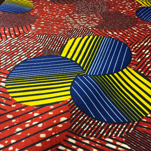 Colorful fabric pattern with blue, yellow, and red shapes