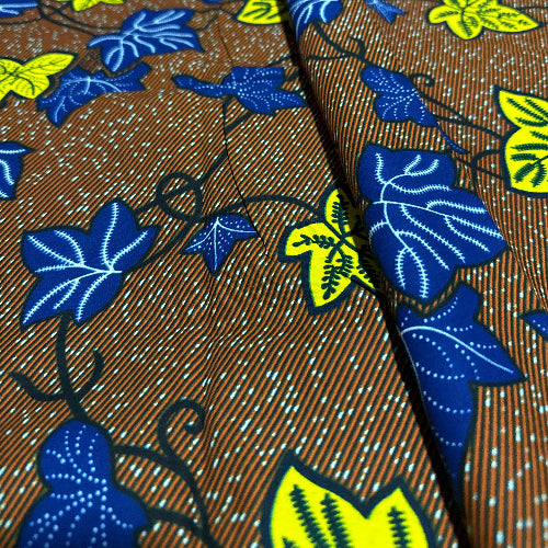 Close-up of fabric with blue and yellow leaf pattern on a brown background
